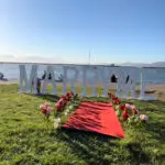 Romantic San Francisco park proposal setup with waterfront view, picnic table, greenery, and 4ft LED “Marry Me” lights by Moonlit Adore.